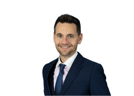 a man in a suit and tie smiles for the camera